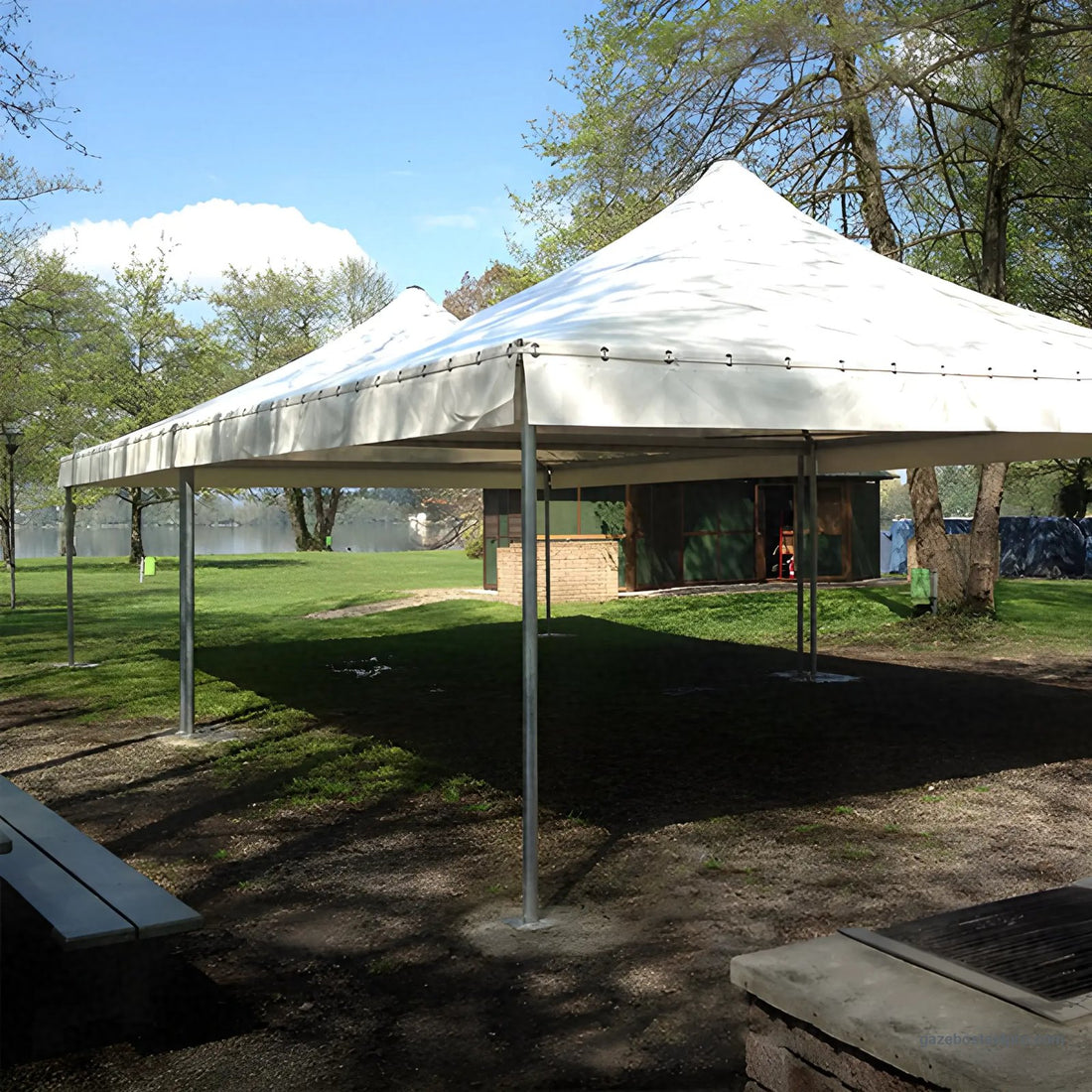 Due gazebo Corallo Light affiancati con telo bianco e tetto a punta in un parco, aperti su tutti i lati, foto vera